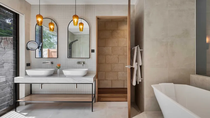 The crisp white and stone interior of the bathroom with double sinks at Sequoia Lodge.
