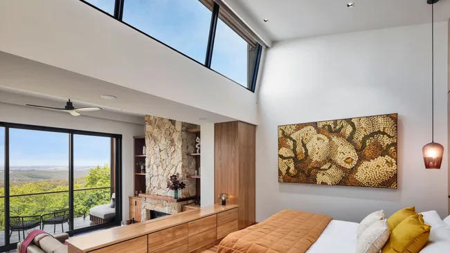Earthy tones and whitewashed walls in the bedroom suite at at Sequoia Lodge.