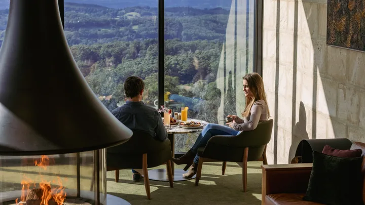 Breakfast in the lounge with a cosy fire pit and floor to ceiling views over the countryside at Sequoia Lodge.