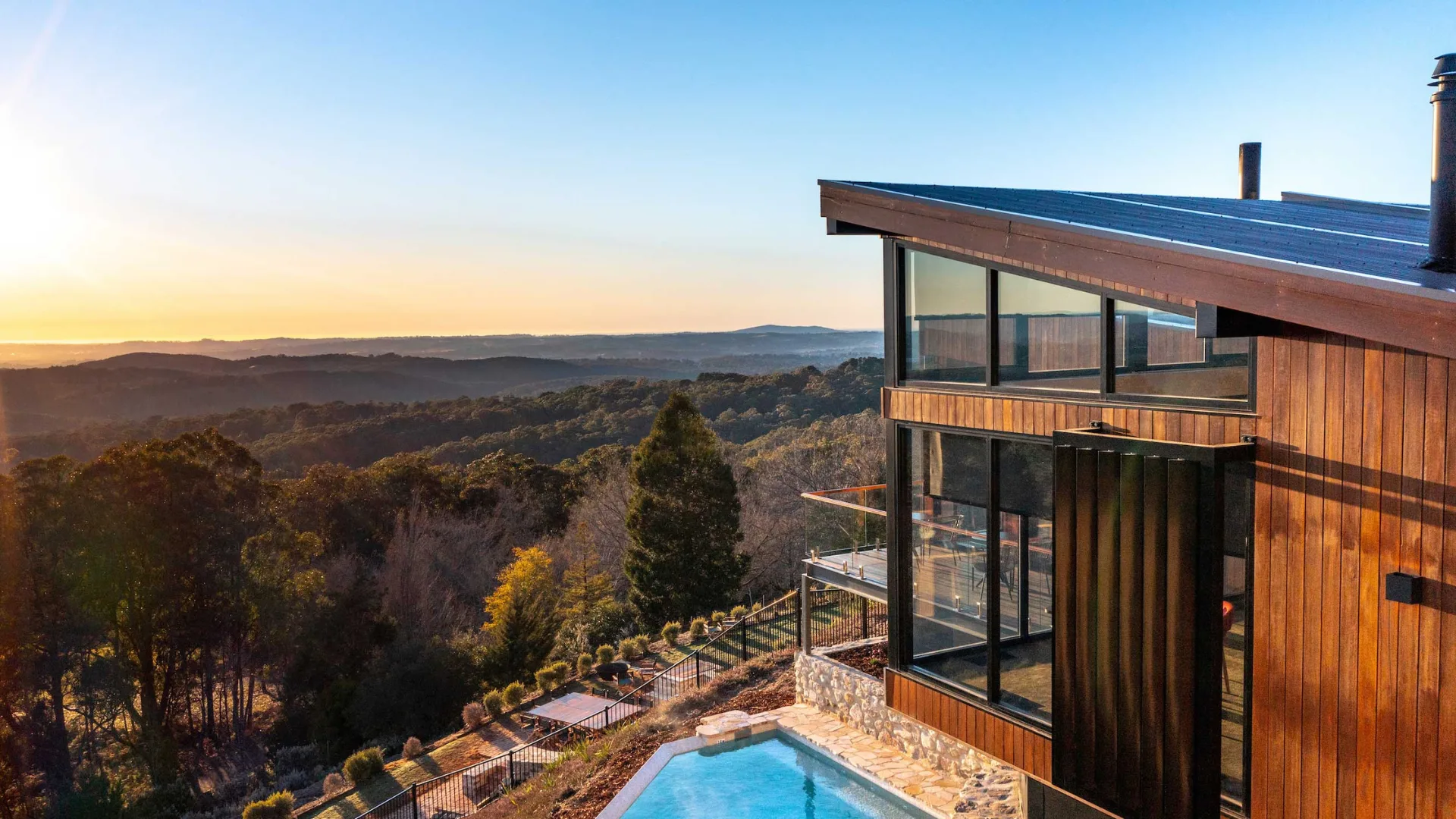 The exterior of Sequoia Lodge with pool and deck overlooking the mountains.