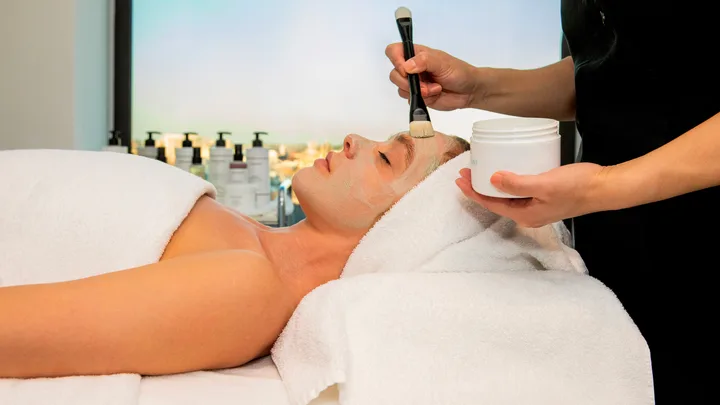 A woman enjoys a facial at the spa at Sheraton Grand Sydney