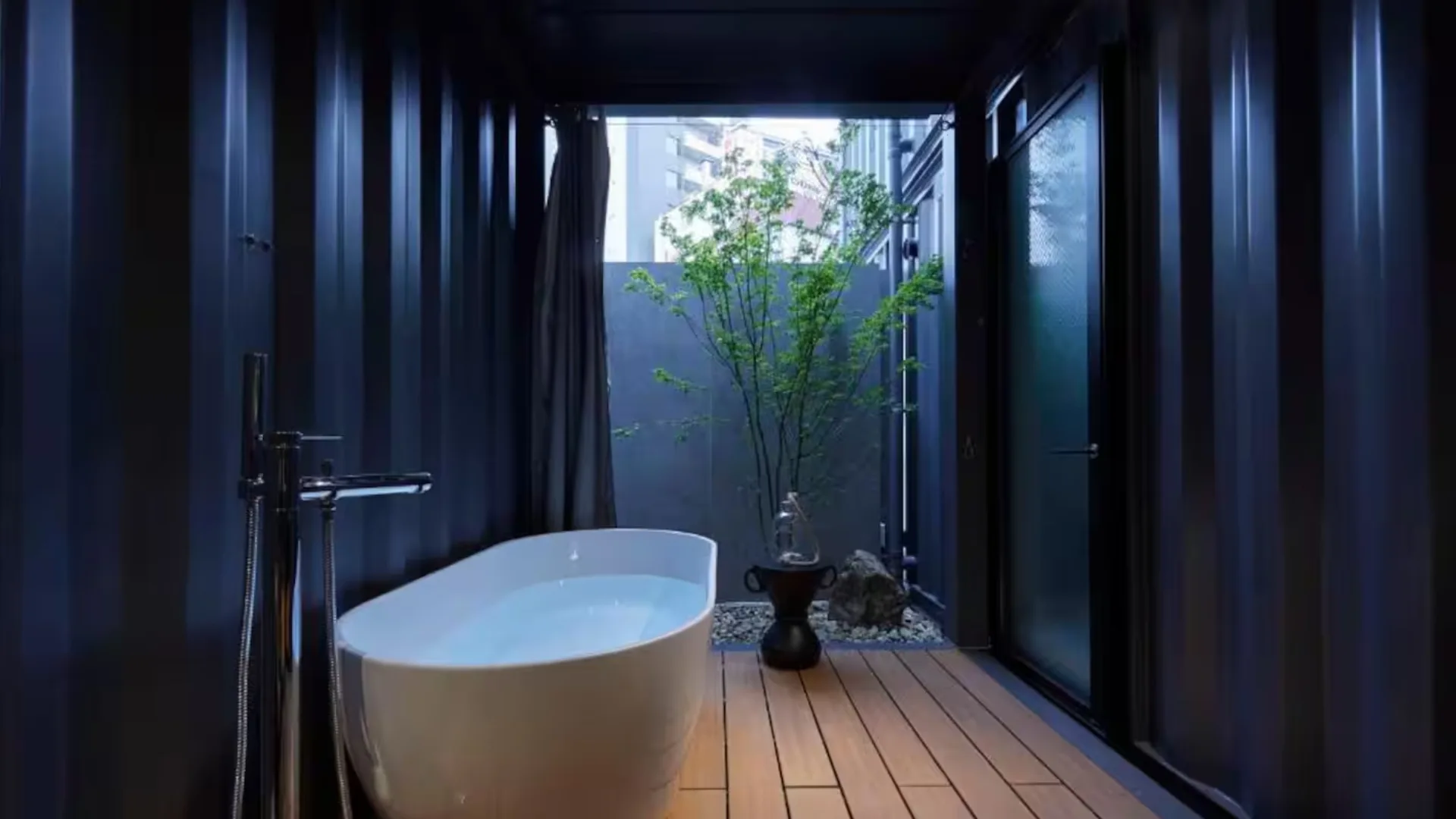 An open-air bathtub in a shipping container Airbnb in Osaka
