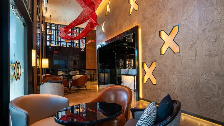 The elegant red-and-gold champagne bar at Sofitel Adelaide