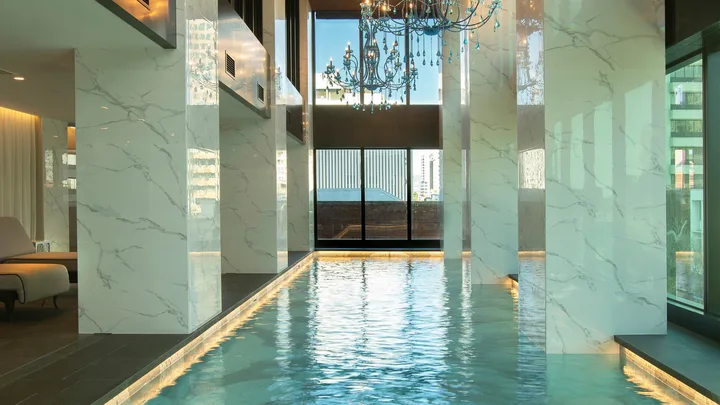 The indoor pool at Sofitel Adelaide is decked out with marble and chandeliers