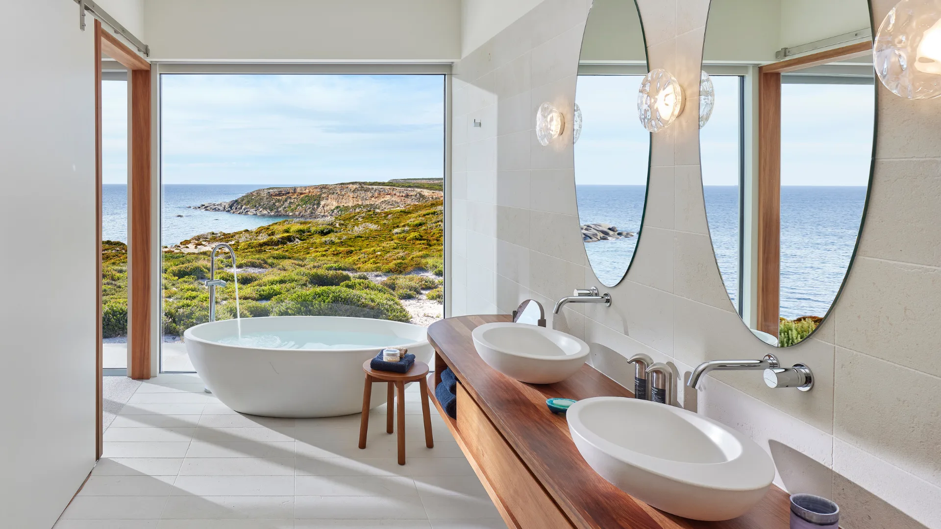 The Pavilion bathroom at Southern Ocean Lodge features freestanding tub with views and double sinks