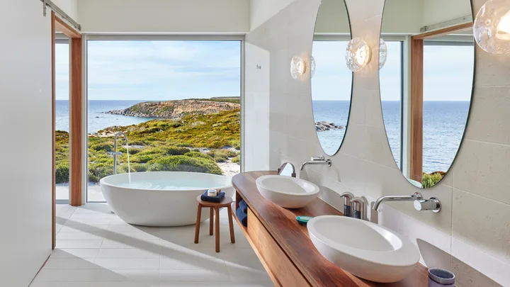 The Pavilion bathroom at Southern Ocean Lodge features freestanding tub with views and double sinks