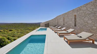 Sun loungers and a pool terrace at the spa at Southern Ocean Lodge