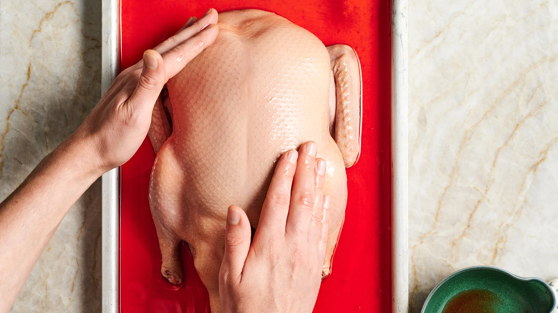 Massaging duck with glaze.