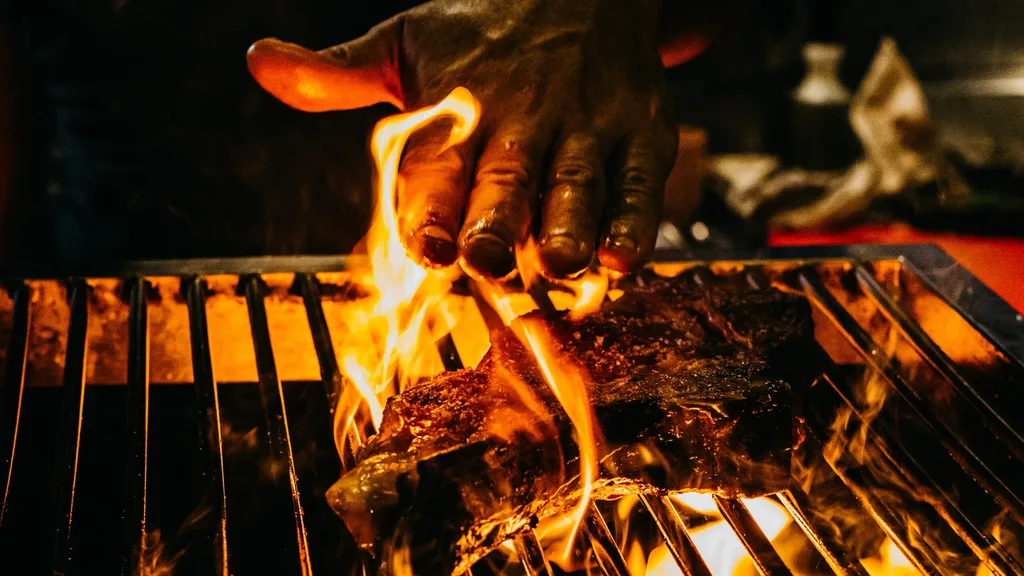Lennox Hastie cooking steak over fire at Firedoor.