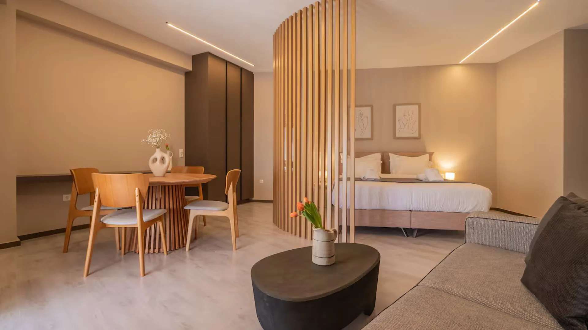image of open plan studio in athens with bed, dining and living area in view