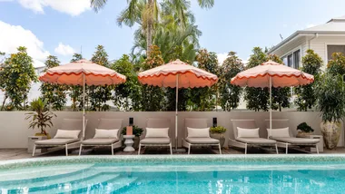 The magnesium outdoor pool with apricot-coloured umbrellas at Basq House in Byron Bay.