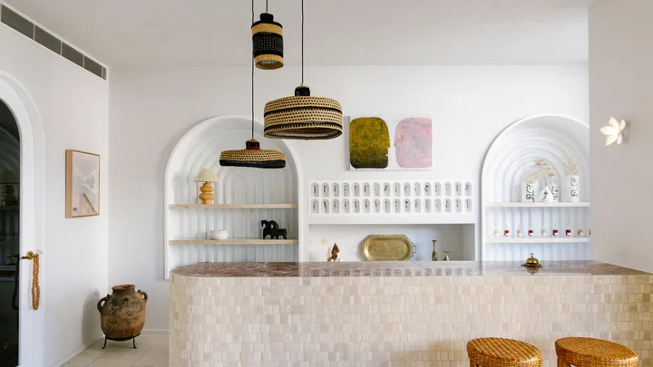 The beachy motel-style reception with white walls and curved lines at Basq House in Byron Bay.