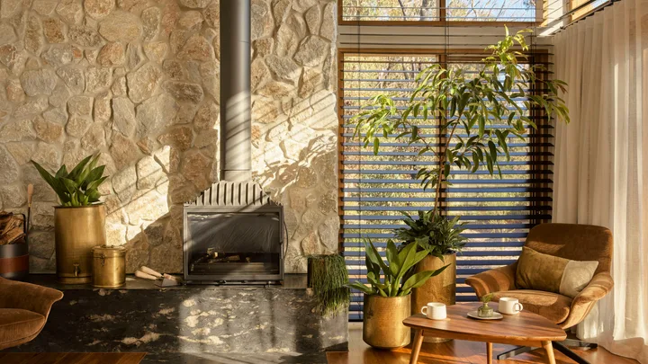 Sun streams in on the cosy interior living room at the Chalets at Blackheath in the Blue Mountains.