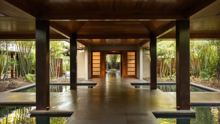 The open air entrance to Spa Qualia with small pools on either side of the timber walkway.