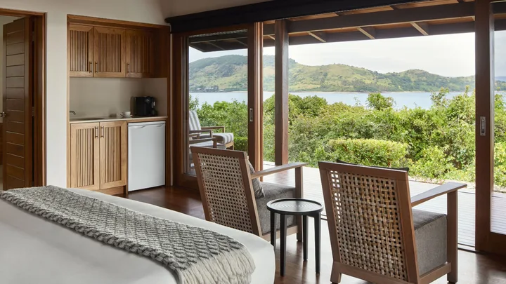 The bedroom suite at the Residence opens out onto a private deck with ocean views at Qualia.