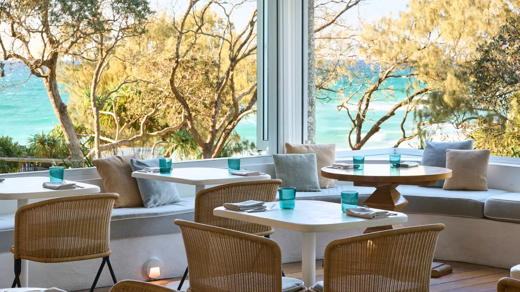 The Dining Room at Raes on Wategos with open-air seating overlooking the ocean.