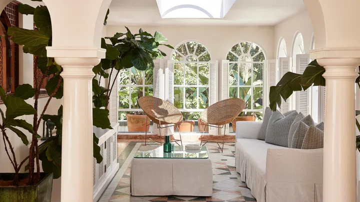 The penthouse at Raes on Wategos with beachy decor, white shutters and cane chairs.
