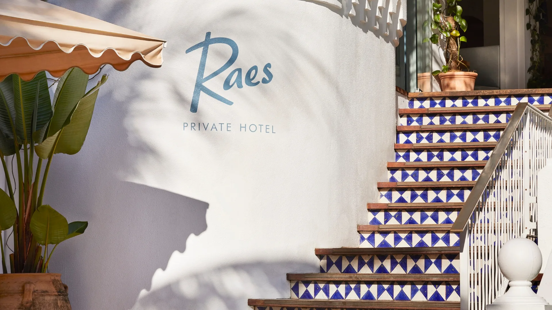 Spanish Mission-style exterior at Raes on Wategos