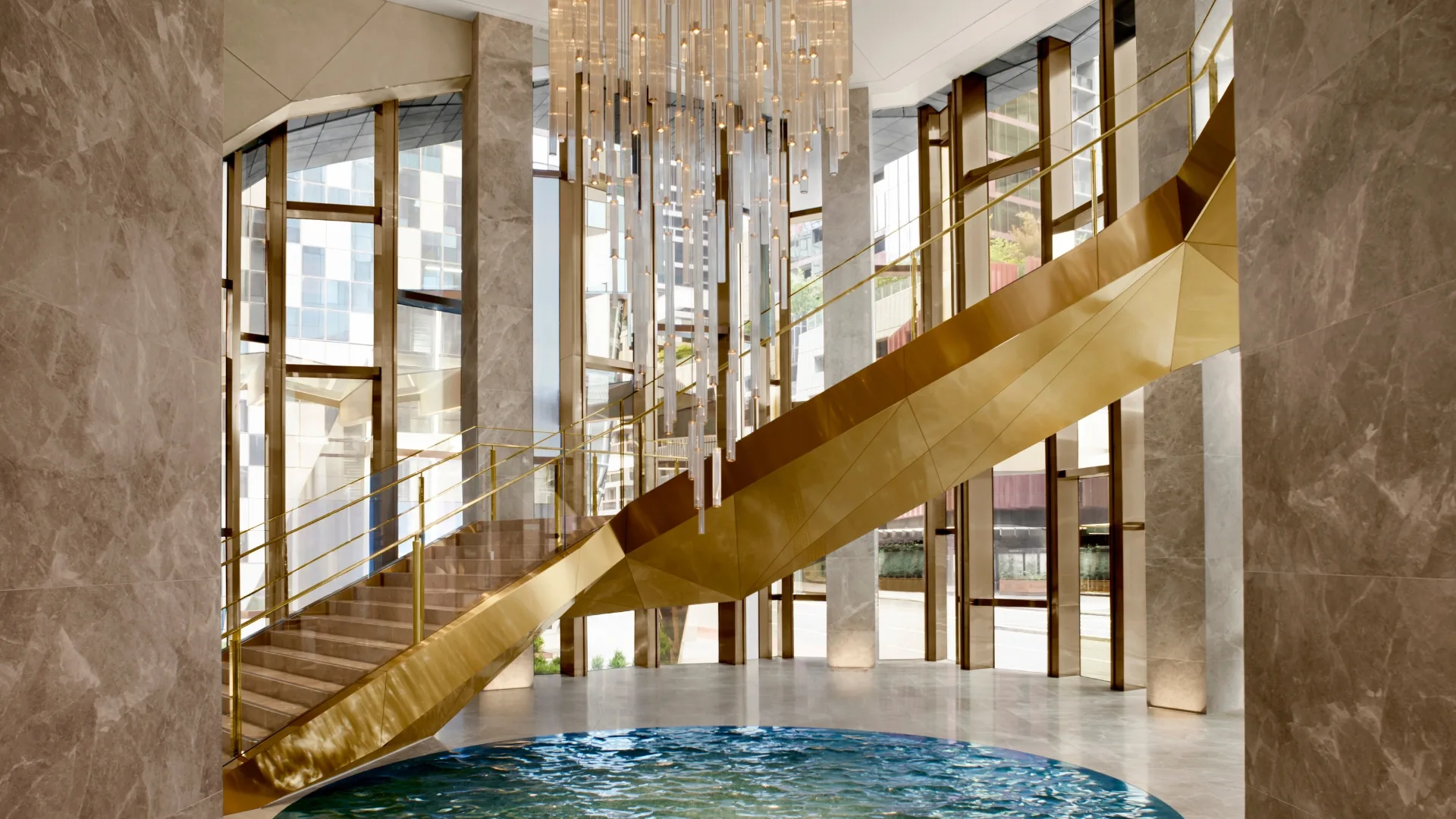 The glamorous lobby and golden staircase at The Ritz-Carlton Melbourne