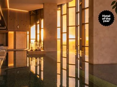 The Ritz-Carlton Melbourne hotel pool at golden hour with Hotel of the Year text