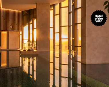 The Ritz-Carlton Melbourne hotel pool at golden hour with Hotel of the Year text