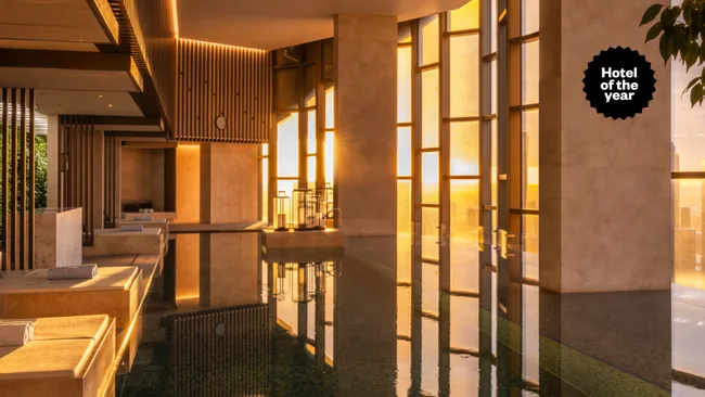 The Ritz-Carlton Melbourne hotel pool at golden hour with Hotel of the Year text