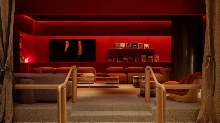 Bang Restaurant with moody red lighting and timber seating at StandardX Melbourne
