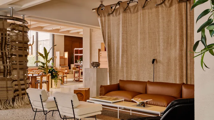 Oat-coloured neutral seating and curtain in the lounge at StandardX Melbourne