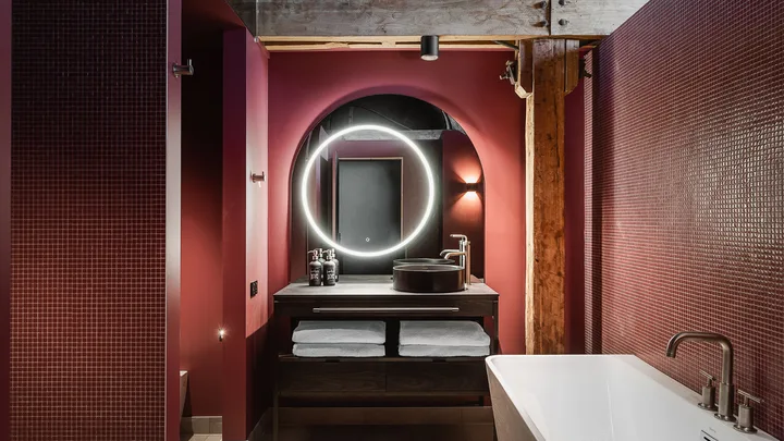 Burgundy and dark timber tones in the bathroom at Stillwater Seven, Launceston