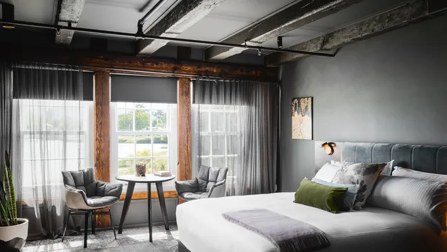 Crisp white and cool grey decor in the bedroom suite at Stillwater Seven, Launceston