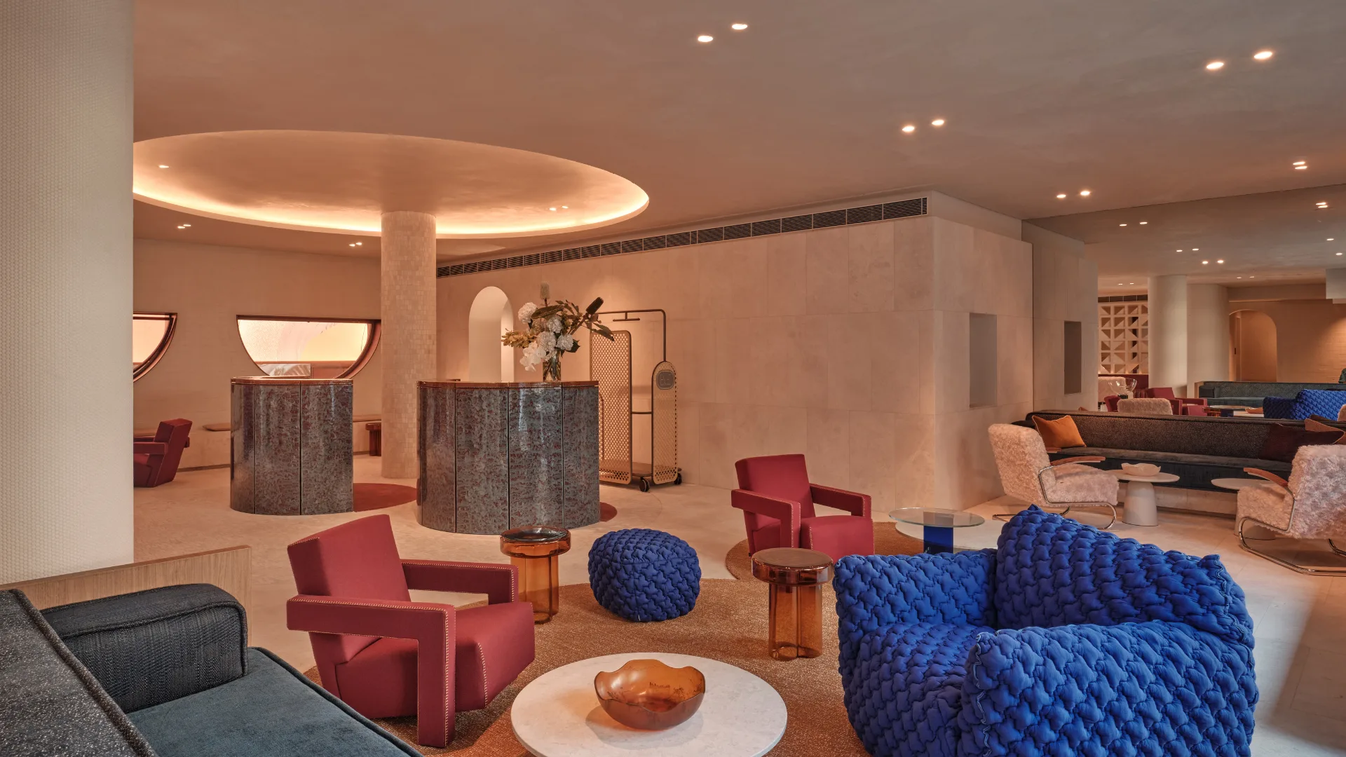 The sleek lobby at The Eve Hotel, Sydney with colourful armchairs and pops of colour