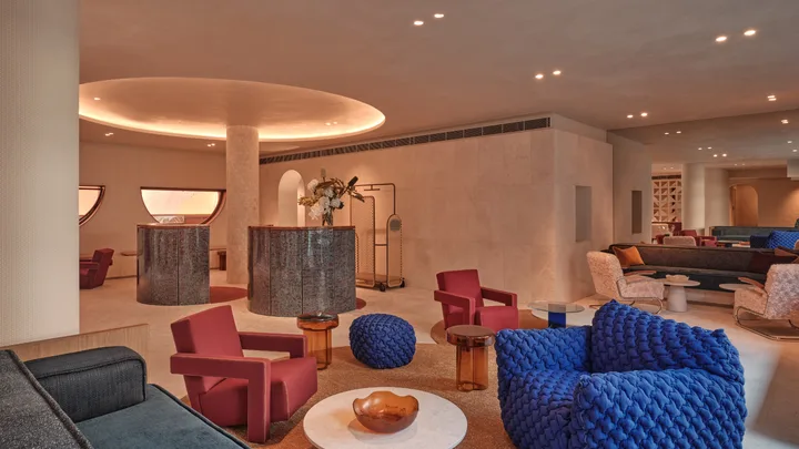 The sleek lobby at The Eve Hotel, Sydney with colourful armchairs and pops of colour