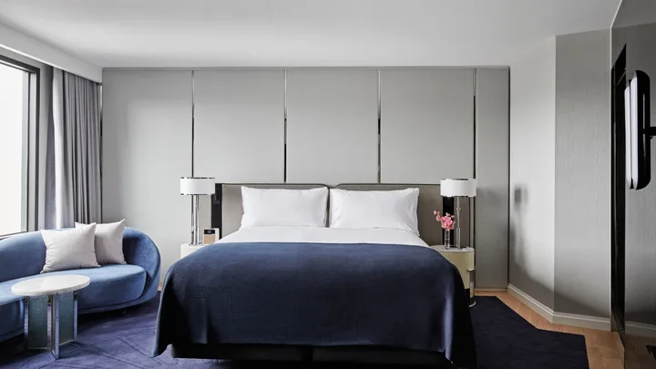 The plush cobalt blue and white decor in the bedroom of the Deluxe Room at the Royce Hotel, St Kilda