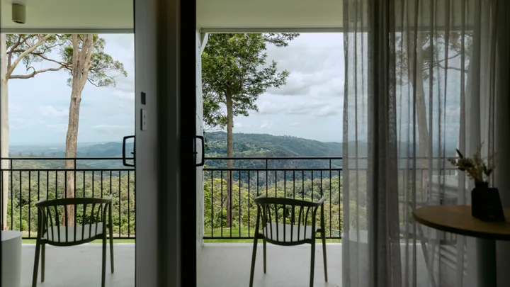 A balcony overlooking treetops and mountain ranges at The Tamborine, Queensland