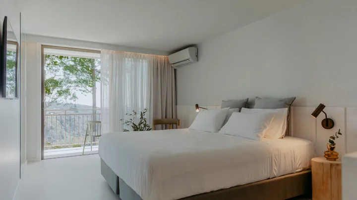The crisp white interior of a bedroom suite at The Tamborine, Queensland