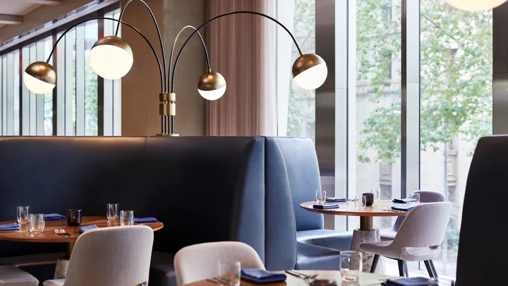 Navy banquette seating and large lamps grace Lollo restaurant at W Melbourne.