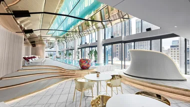 The bright, luxe indoor 'Wet' pool with sun loungers and DJ Booth at W Melbourne.
