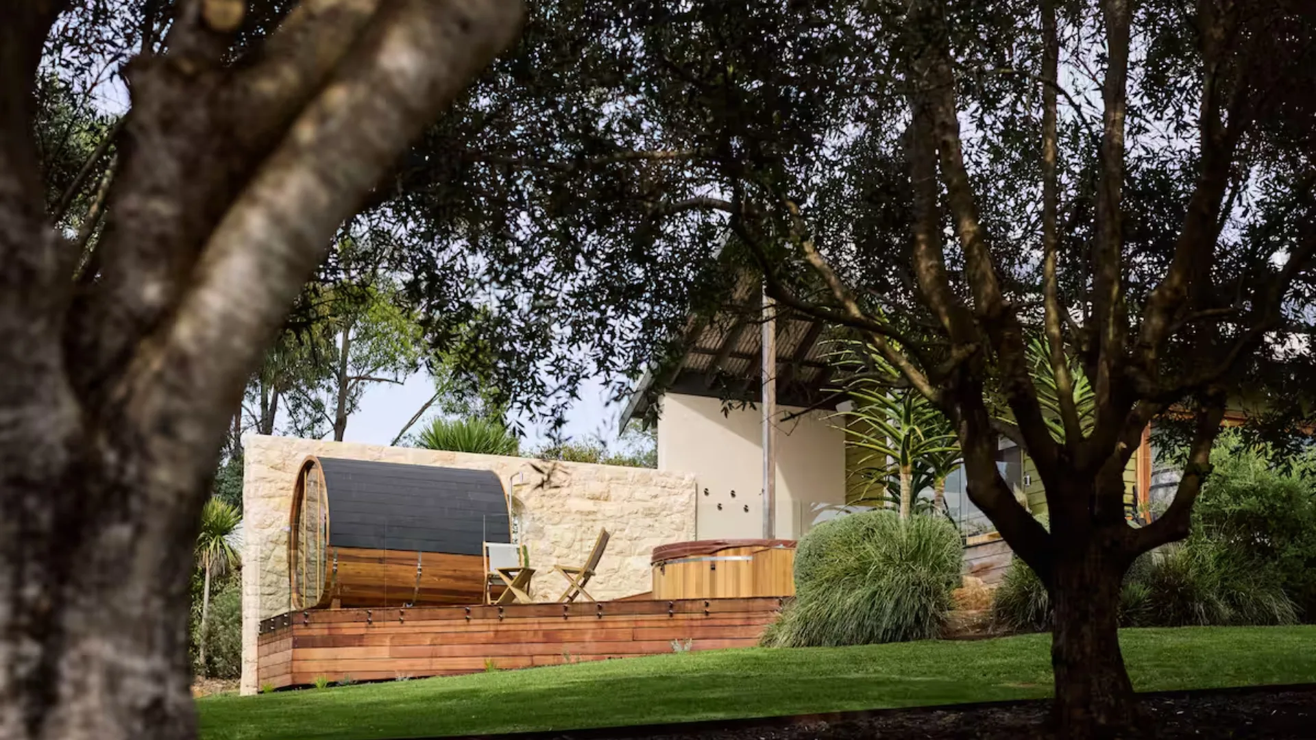 Trees frame the Villa Saltus deck with wooden sauna and hot tub