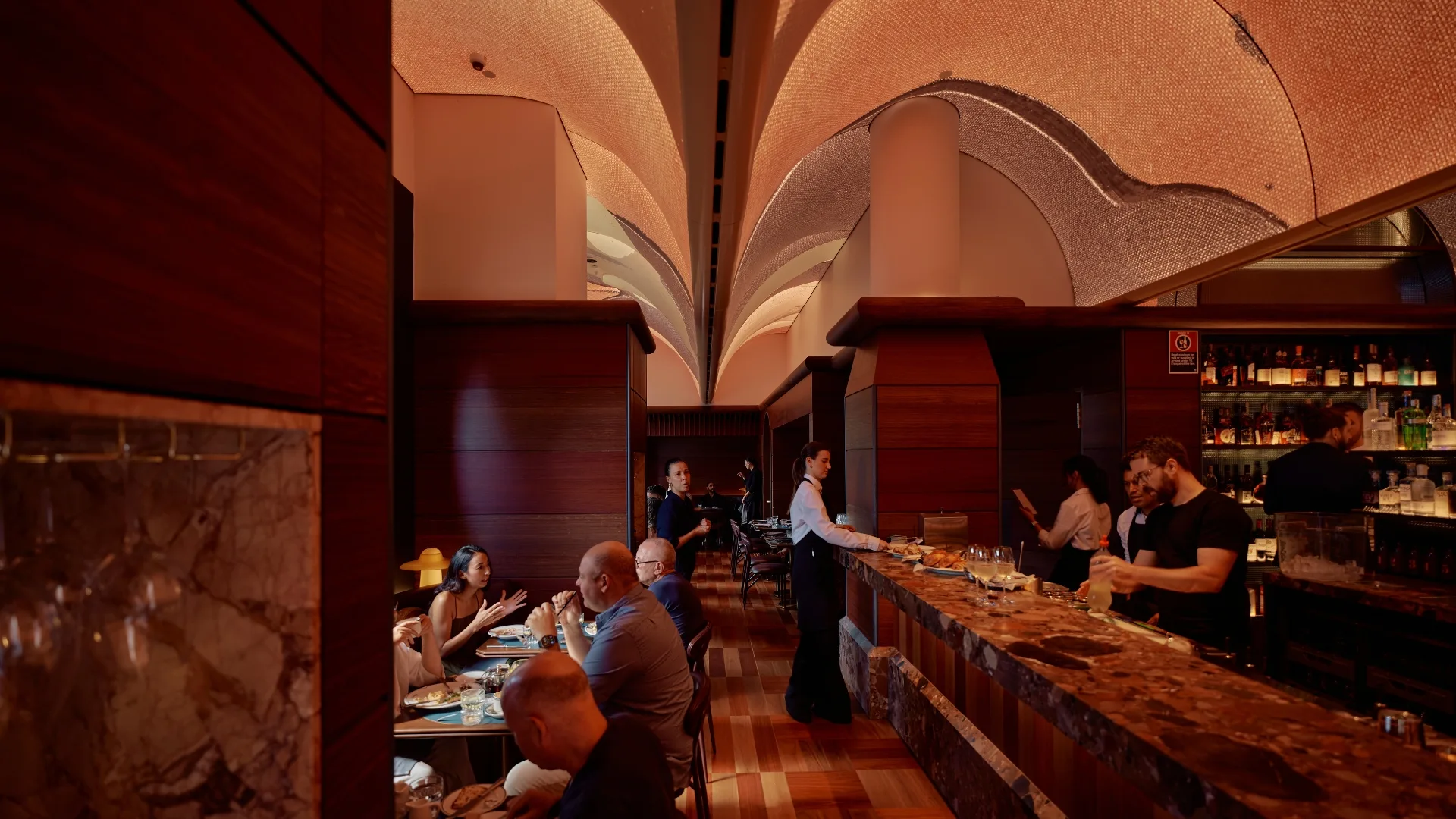 High arched ceilings and pink hues set the mood at Bar Julius in redfern, one of the best bars in Sydney.