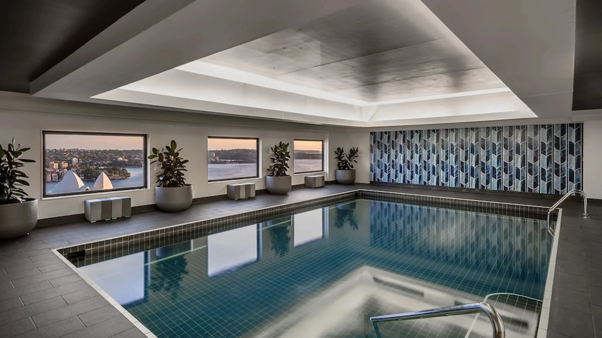 The indoor pool at InterContinental Sydney, with a hint of the Opera House and stunning harbour views from the window.