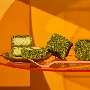 Pistachio lamingtons with bright orange background