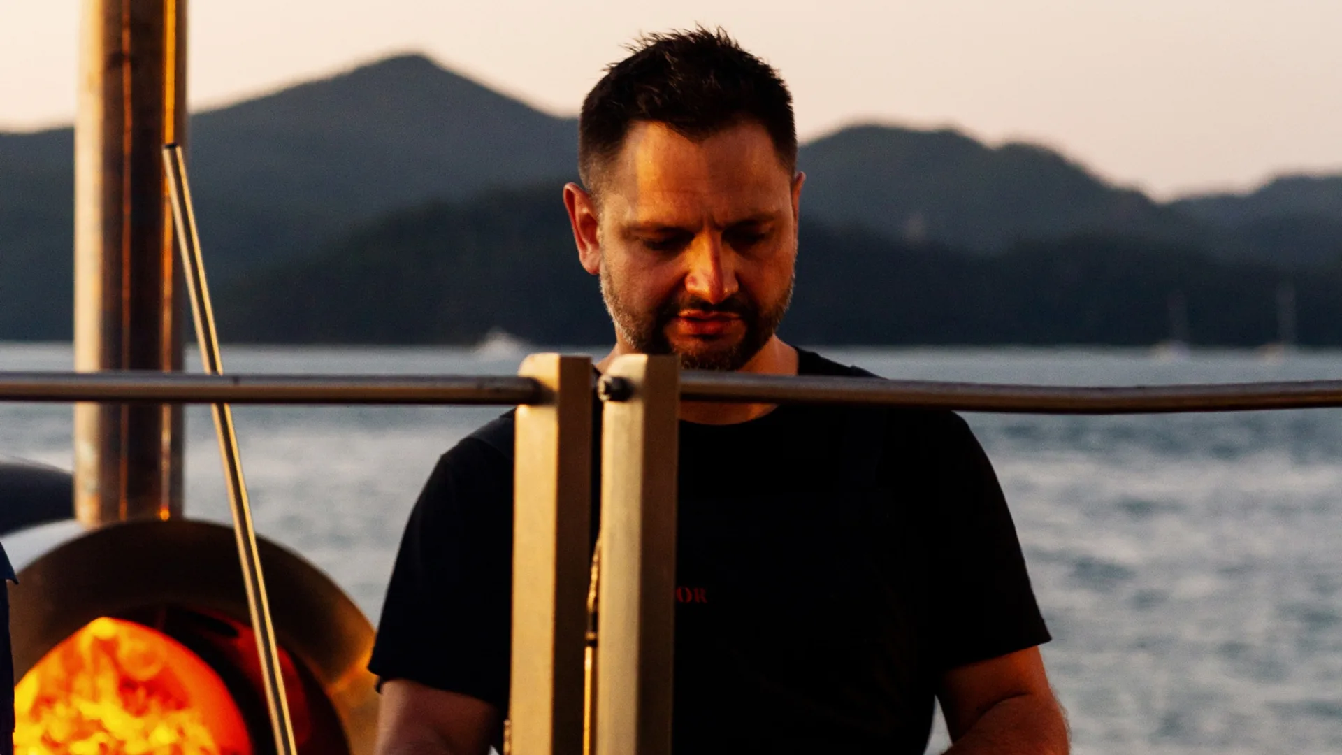Chef Lennox Hastie cooking with fire on the beach