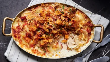 An overhead shot of baked potato gratin covered with baked breadcrumbs and thyme