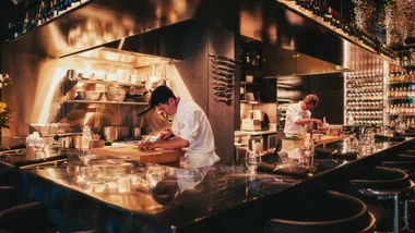 Photograph of father and son chefs Raita Noda (right) and Momotaro (left) in the kitchen.