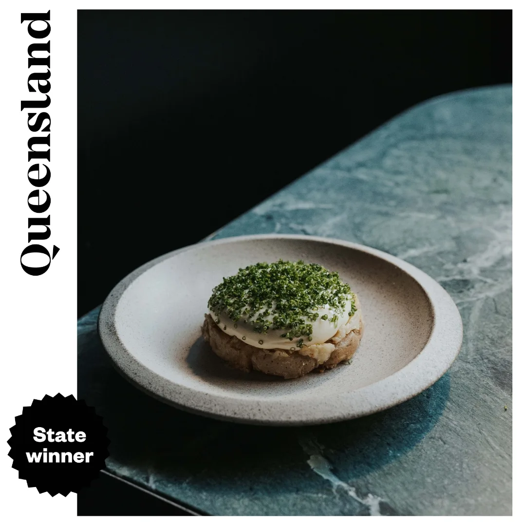 A dish on a teal coloured marble table at Essa, the best restaurant in Queensland