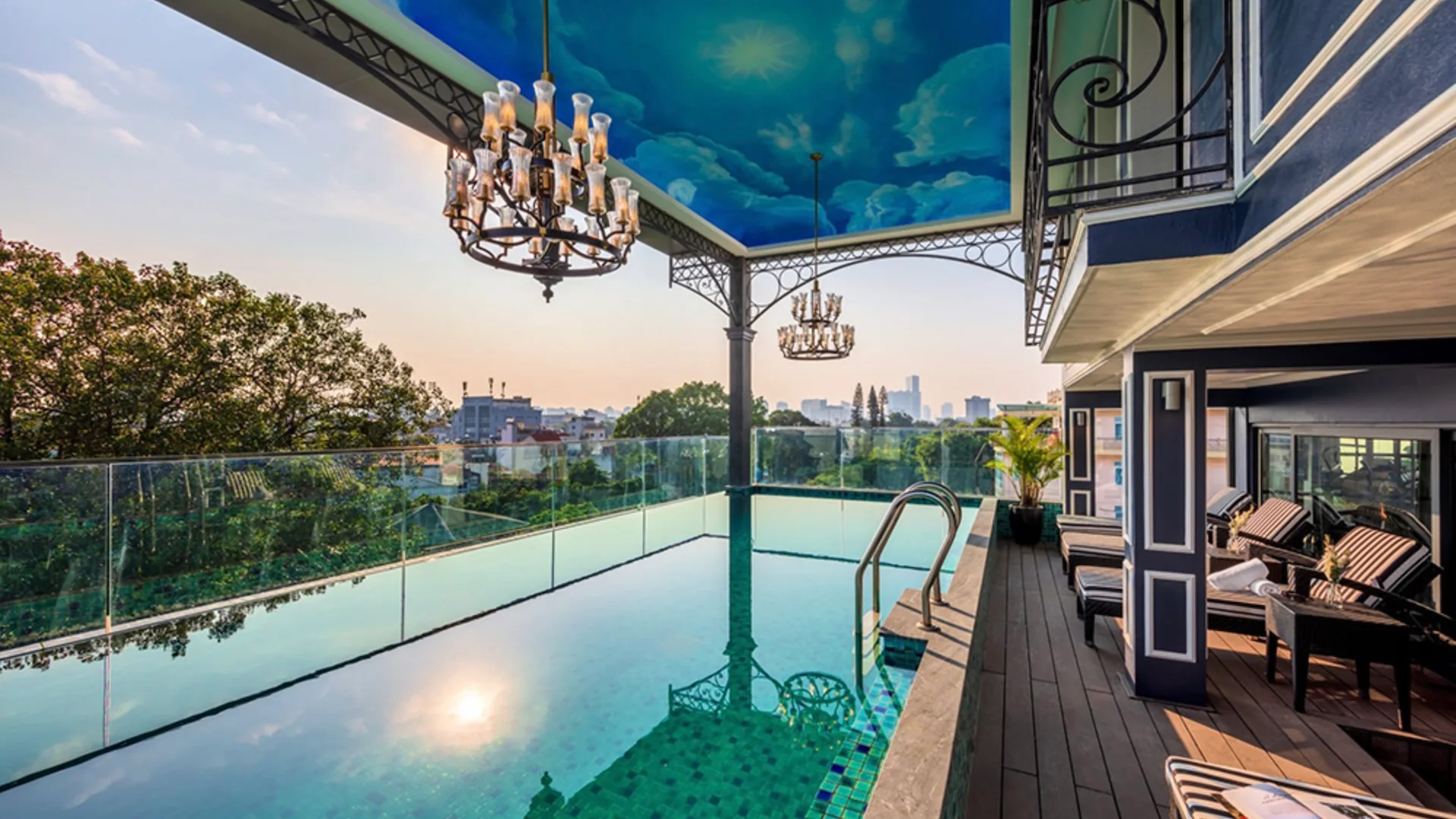 The Aira Boutique Hanoi Hotel has a covered outdoor pool with glamourous lighting and a sky motif on the roof.