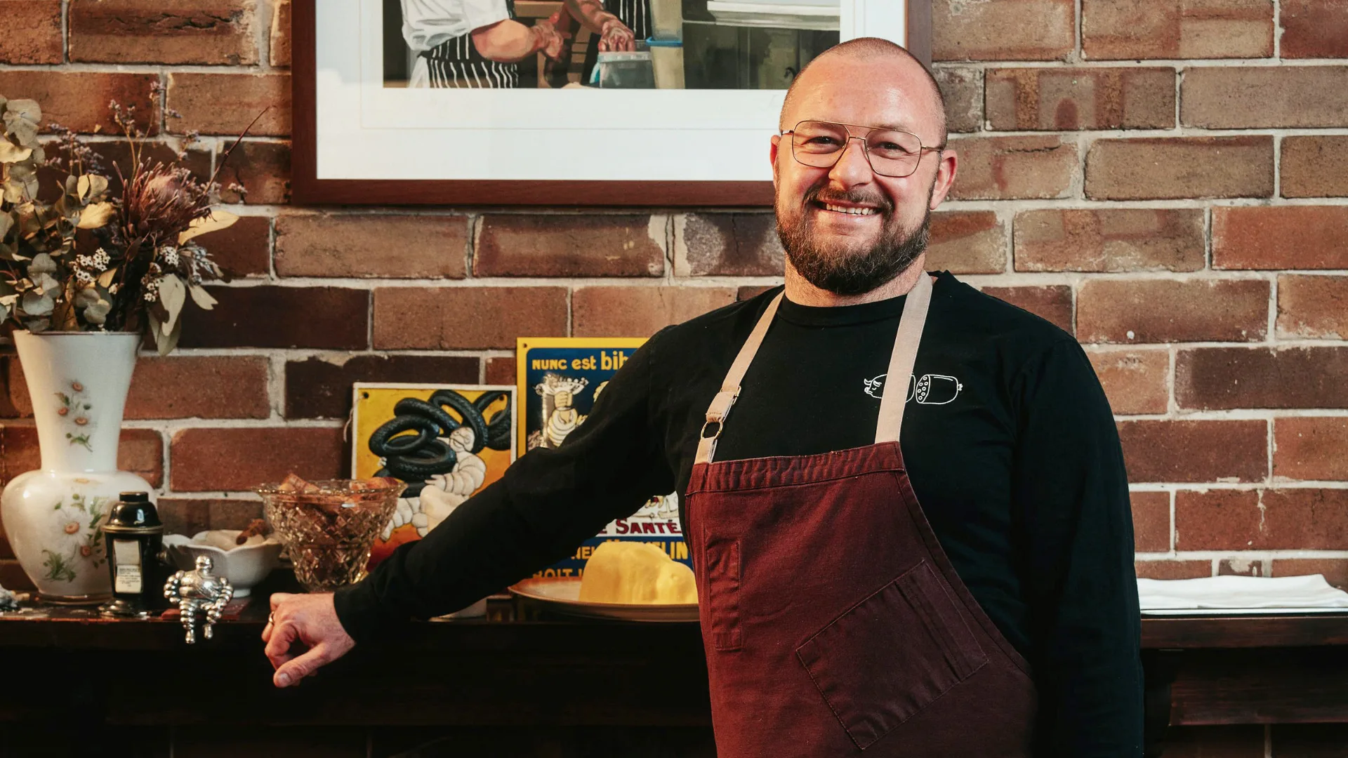 Chef Nik Hill of Porcine stands at the fireplace in his Paddington restaurant.
