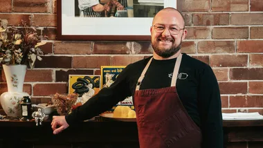 Chef Nik Hill of Porcine stands at the fireplace in his Paddington restaurant.