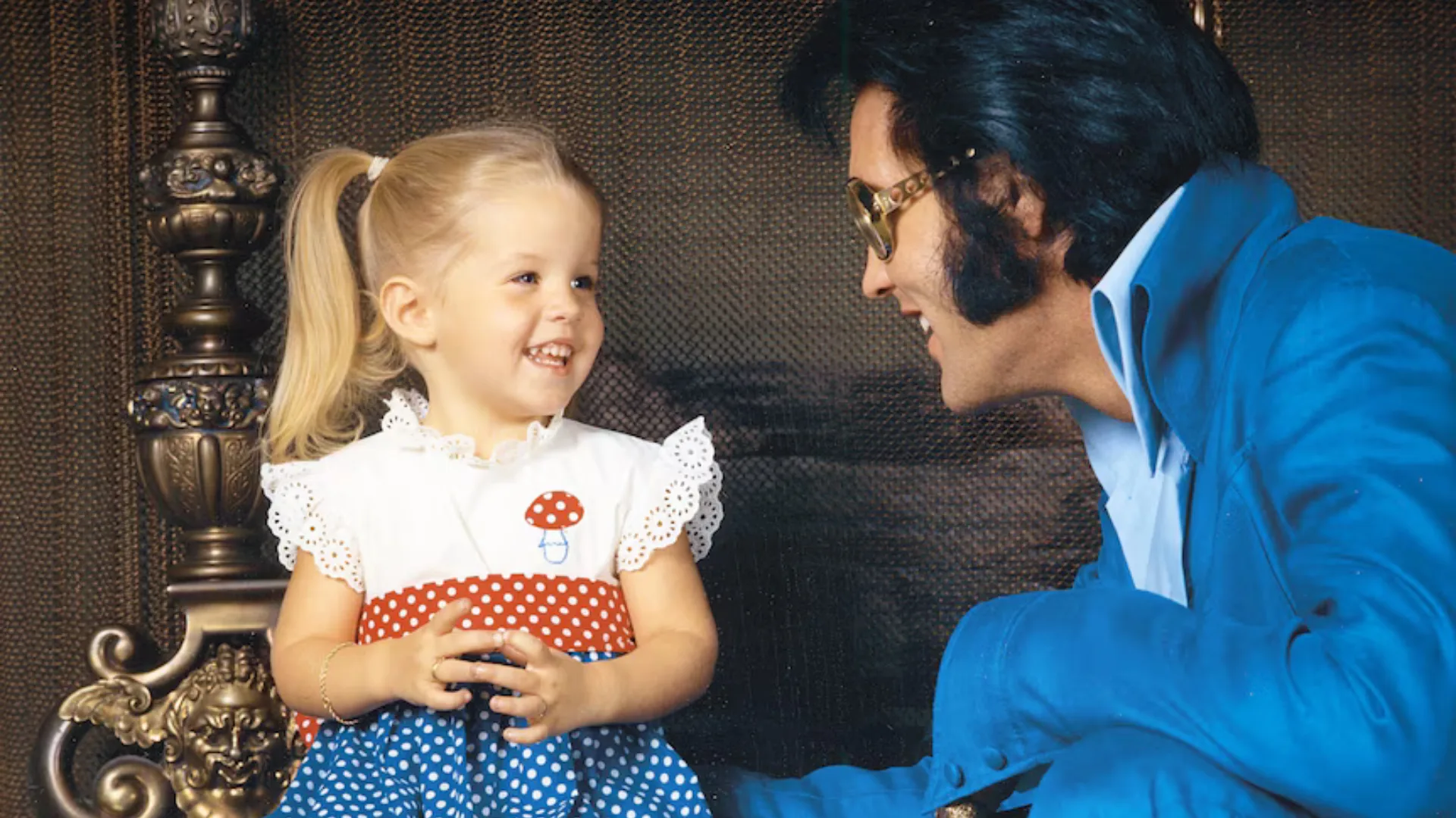 A retro photograph of a young Lisa-Marie and Elvis Presley.