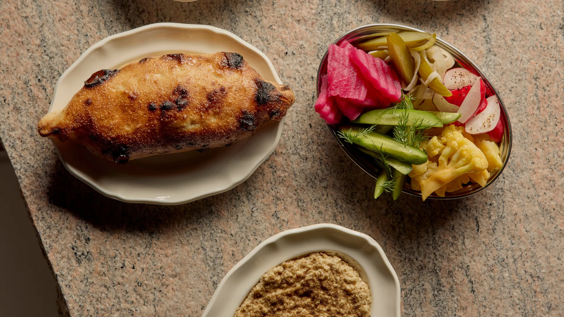 A wood-fired bread, colourful pickles, and plate of dip at Brisbane restaurant Golden Avenue.